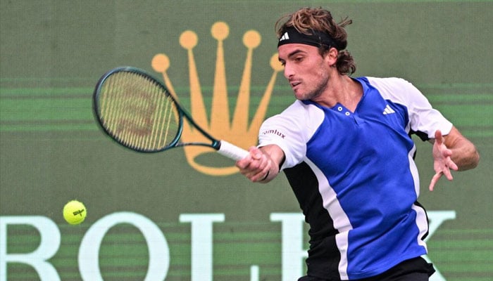 Greeces Stefanos Tsitsipas hits a return to Japans Kei Nishikori during their match at the Shanghai Masters. — AFP/file