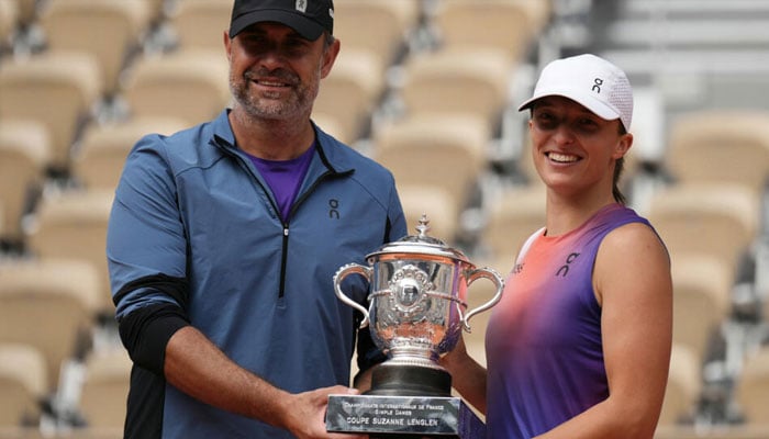 Worldd number one Iga Swiatek with her coach Tomasz Wiktorowski after winning the French Open in Paris in June 2024. — AFP