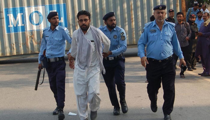 Police personal arrest a PTI activist at D Chowk in Islamabad on Oct 4, 2024. —  INP