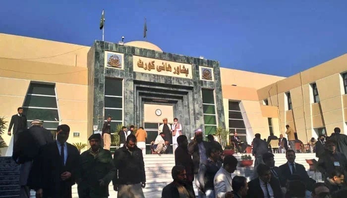 People are seen gathered outside the Peshawar High Court (PHC). — APP/File