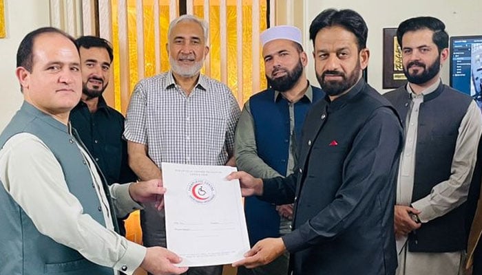 Paraplegic Centre Peshawar Chief Executive Officer Dr Syed Muhammad Ilyas seen in the middle of the group, launching a dedicated clinic in Muzaffarabad, the capital of Azad Kashmir. on Oct 3, 2024. — Facebook/paraplegiccenterpeshawar