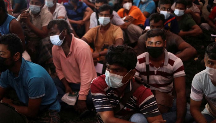 Migrant workers gather at the compound of their dormitory for a document check, during a joint operation by the Department of Labour and several other Malaysian government agencies on workers living condition and other criteria of forced labour and human trafficking, in Kuala Lumpur, Malaysia, March 17, 2022. — Reuters