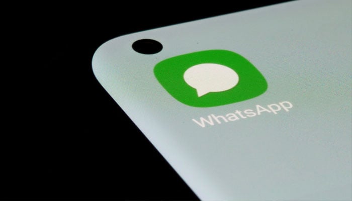 A representational image of the WhatsApp logo displayed on a phone screen. — Unsplash