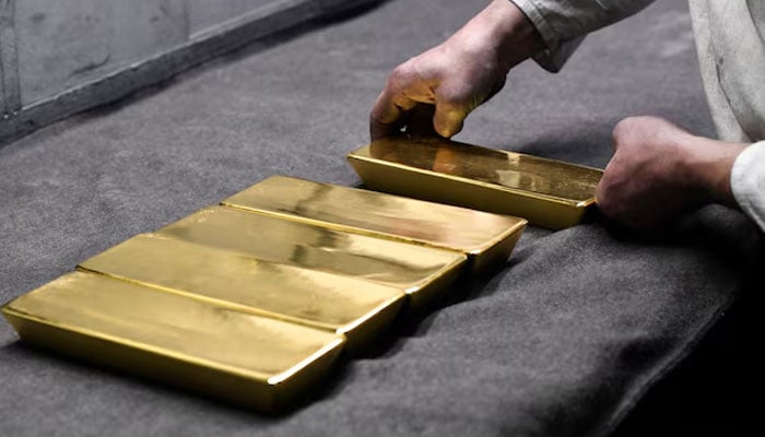 An employee places ingots of 99.99 percent pure gold in a workroom at the Novosibirsk precious metals refining and manufacturing plant in the Siberian city of Novosibirsk, Russia, on September 15, 2023. — REUTERS