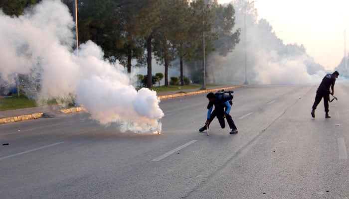 Police personal fire tear gas shell to ward protestors after clash between police and PTI activities at D Chowk in Islamabad on Oct 4, 2024. — INP