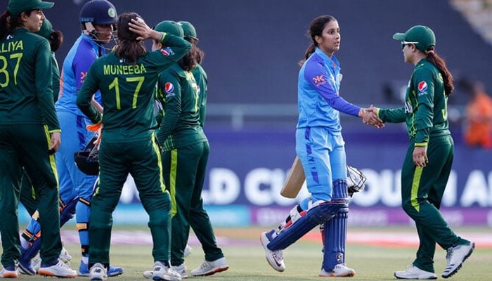 Indias Richa Ghosh (2nd L) and Indias Jemimah Rodrigues (2nd R) are congratulated by Pakistan players after India won the Group B T20 womens World Cup cricket match between India and Pakistan at Newlands Stadium in Cape Town on February 12, 2023. — AFP