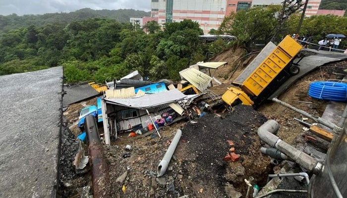 Public utility vehicles are trapped in a landslide near Keelung City’s Bureau of Environmental Protection, which was triggered by heavy rainfall after Typhoon Krathon swept across the island. — AFP