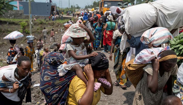 Congolese people carry their belongings as they flee from their villages around Sake in Masisi territory, following clashes between M23 rebels and the Armed Forces of the Democratic Republic of the Congo (FARDC); towards Goma, North Kivu province of the Democratic Republic of Congo February 7, 2024.  — REUTERS