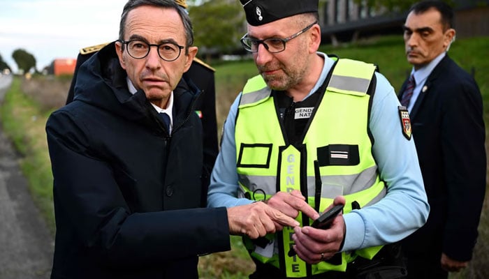 France’s Minister of the Interior Bruno Retailleau (left) listens to French gendarmes during a French gendarmerie operation on the A83 highway toll in Les Essarts, western France, on Oct 4, 2024— AFP