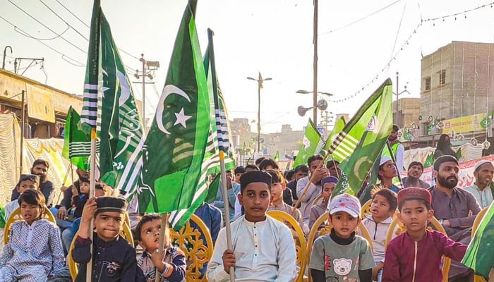 Pakistan Markazi Muslim League (PMML) supporters and workers hold party flags at a public gathering in Orangi Town, Karachi on December 23, 2023. — Facebook/Pakistan Markazi Muslim League - Karachi