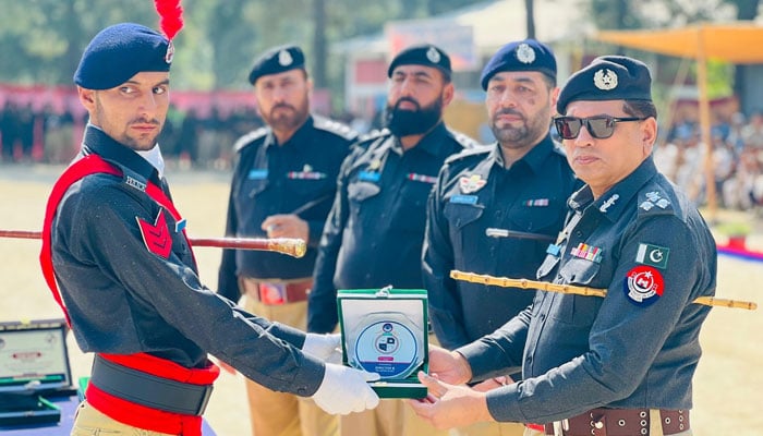 Additional Inspector General of Police (Training) Dr Akhtar Abbas presents a shield to a cop during 46 Passing Out Parade at the Police Training School on October 5, 2024. — Facebook/Khyber Pakhtunkhwa Police