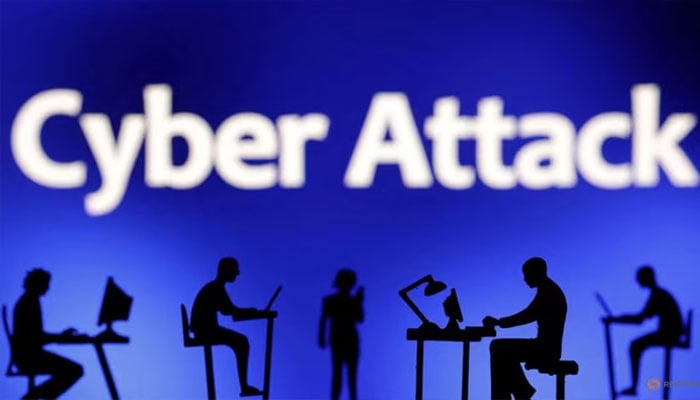 Figurines with computers and smartphones are seen in front of the words Cyber Attack in this illustration taken, February 19, 2024. — Reuters