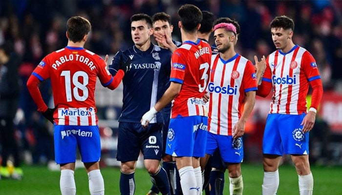 Real Sociedads Spanish forward Ander Barrenetxea greets Gironas Spanish midfielder Pablo Torre at the end of the Spanish league football match between Girona FC and Real Sociedad at the Montilivi stadium in Girona on February 3, 2024. — AFP