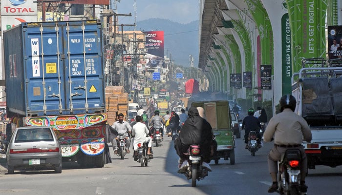 People on their way to Murree Road after opening roads in the city, after the turmoil of three days the daily life activities started again in Rawalpindi on October 6, 2024. — Online