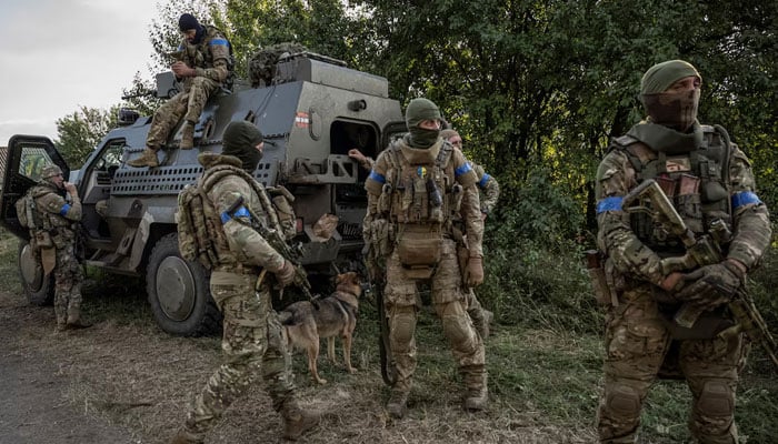 Ukrainian servicemen stand near a military vehicle near the Russian border in Sumy region, Ukraine August 16, 2024. — Reuters