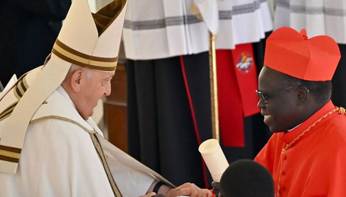 Pope Francis with one of his cardinals. — AFP/file