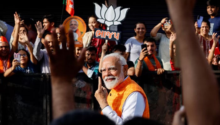 Indias Prime Minister Narendra Modi shows his ink-marked finger after casting his vote during the third phase of the general election, in Ahmedabad, India, May 7, 2024. — Reuters