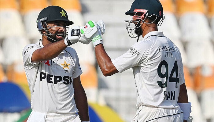 Pakistan’s Abdullah Shafique celebrates wtih captain Shan Masood (R) after scoring a century during the first day of the first Test cricket match between Pakistan and England at the Multan Cricket Stadium in Multan on October 7, 2024. — AFP