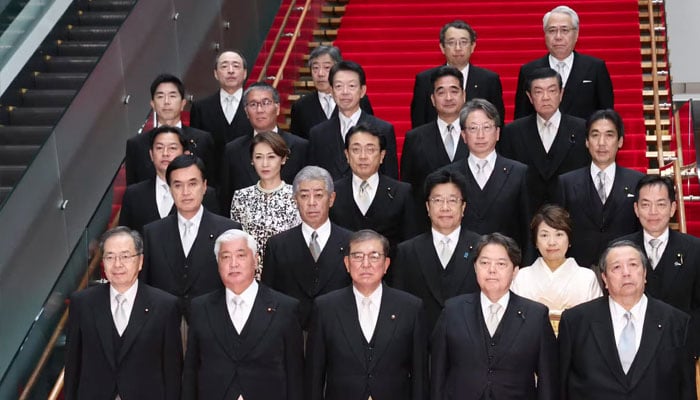 This picture taken on October 1, 2024 shows Japan’s new Prime Minister Shigeru Ishiba (front C) posing during a photo session with the members of his cabinet at the prime minister’s official residence in Tokyo. — AFP