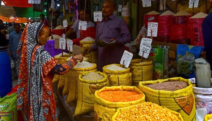 A customer buys rice at a wholesale shop. — AFP/File