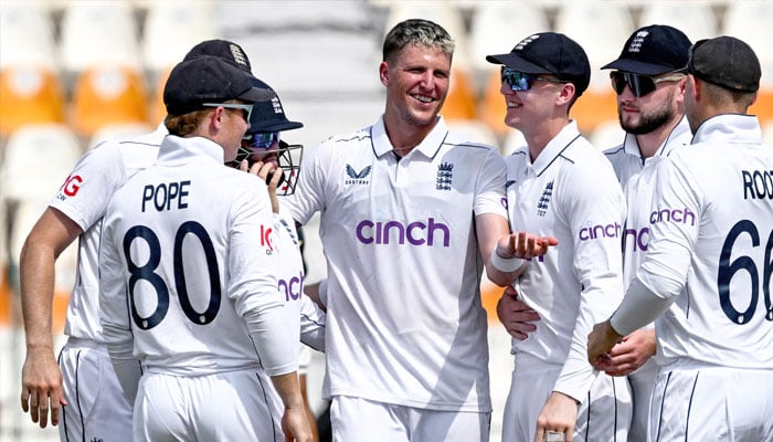 England´s Brydon Carse (center) celebrates with teammates after taking the wicket of Pakistan´s Naseem Shah during the second day of the first Test cricket match between Pakistan and England at the Multan Cricket Stadium in Multan on October 8, 2024. — AFP