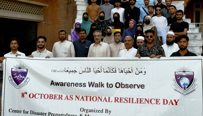 Participants hold a banner  to mark National Resilience Day and International Day for Disaster Risk Reduction awareness walk organised by CDPM on October 8, 2024. — Facebook/Centre for Disaster Preparedness & Management Peshawar (CDPM)