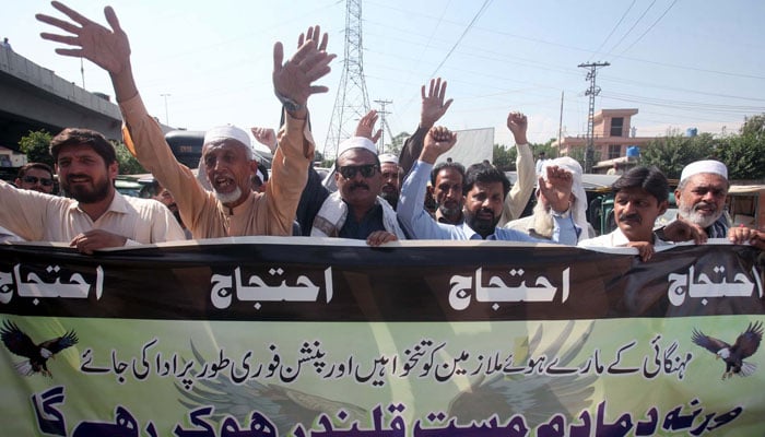 Members of the United Municipal Worker Union block the road as they are holding a protest demonstration against non-payment of their dues salaries and pensions, at Bacha Khan Chowk in Peshawar on October 8, 2024. — PPI