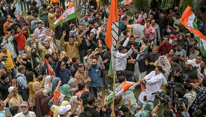 Supporters of Indian National Congress (INC) party celebrate outside the partys office in Srinagar on October 8, 2024, as counting of votes is underway for the local assembly elections in Indian Illegally Occupied Jammu and Kashmir (IIOJK). — AFP