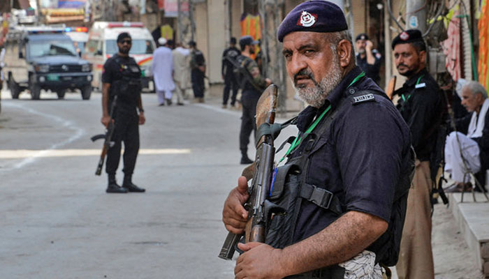 KP police personnel stand guard in Peshawar, on August 7, 2022. — AFP