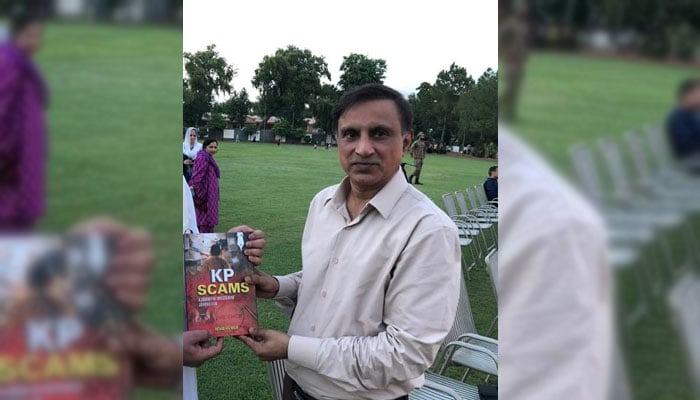 Senior journalist and President of Peshawar Press Club, Arshad Aziz Malil with his book. — Facebook@arshadazizmalikjang/file