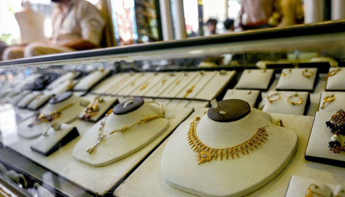 A jeweller waits for a customers at a shop in Karachi on June 26, 2024. — AFP