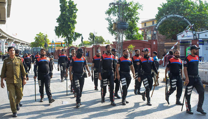 A view of police personnel walking on the Murree road due to PTI protest rally on September 28, 2024. — INP