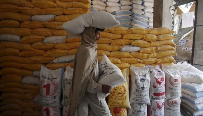 A labourer carrying flour bags. — Reuters/File