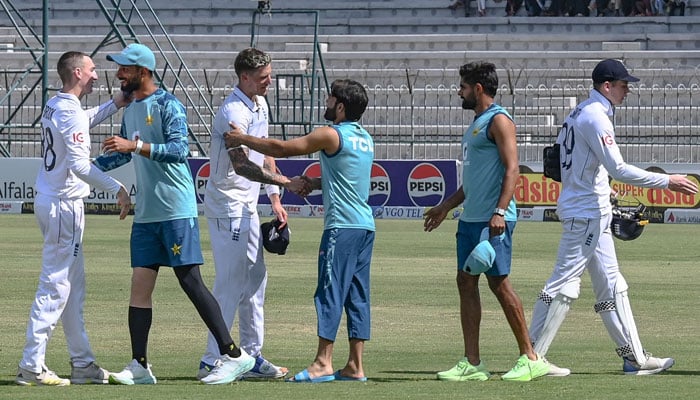 Players shake hands with each other at the end of the first Test cricket match between Pakistan and England at the Multan Cricket Stadium in Multan on October 11, 2024. — AFP