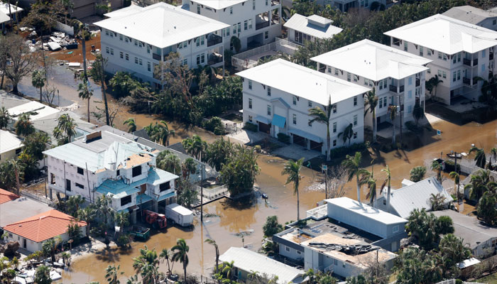 A man removes debris from a house affected after Hurricane Milton made landfall in Englewood, Florida, US, October 11, 2024. — Reuters