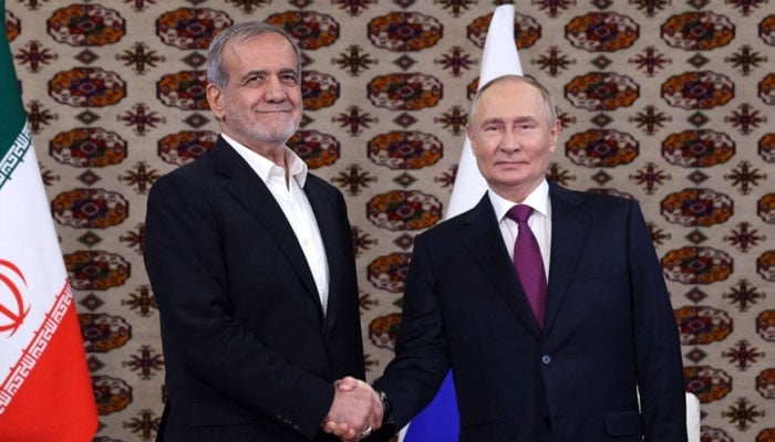 Russian President Vladimir Putin meets Irans President Masoud Pezeshkian on the sidelines of an international forum in Ashgabat, Turkmenistan. — AFP/File