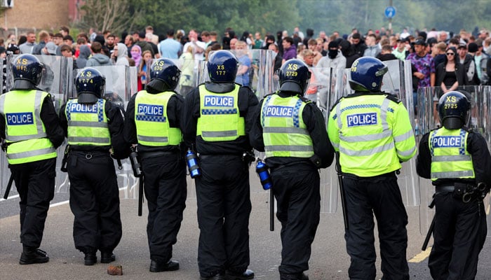 Police officers stand near a broken microphone during an anti-immigration protest, in Rotherham, Britain, August 4, 2024. — Reuters