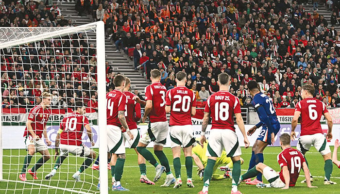 BUDAPEST: Hungary’s goalkeeper Denes Disbusz gets down to save a free kick during the UEFA Nations League, League A Group A3 football match against Netherlands at the Puskas Arena here on Oct 11, 2024.  — AFP