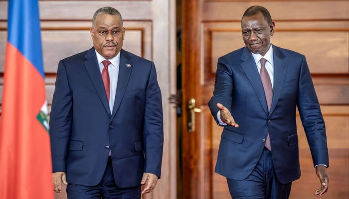 President of Kenya William Ruto (R) gestures during his arrival to a joint press conference with Prime Minister of Haiti Garry Conille (L) at the State House in Nairobi on October 11, 2024. — AFP