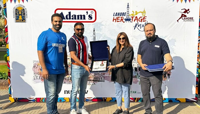 Participants present certificates at a running competition organised by the Walled City of Lahore Authority (WCLA) on October 13, 2024. — Facebook/Walled City Lahore Authority