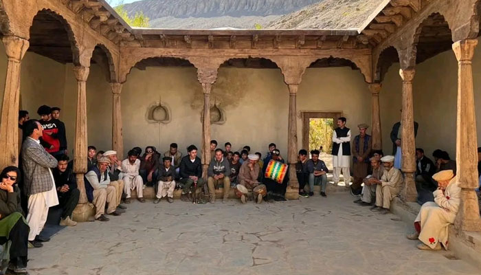 This image taken on October 13, 2024, shows people sitting in the Gholbasher Houses lawn in Barkolti village of the Yasin valley of the Ghizer district of Gilgit-Baltistan. — Facebook/Yasin Ghizer official