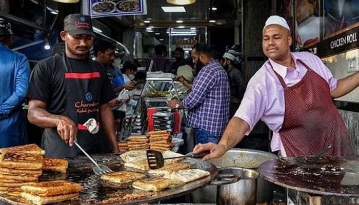 A representational image showing two people working at  roadside eatery. — AFP/File