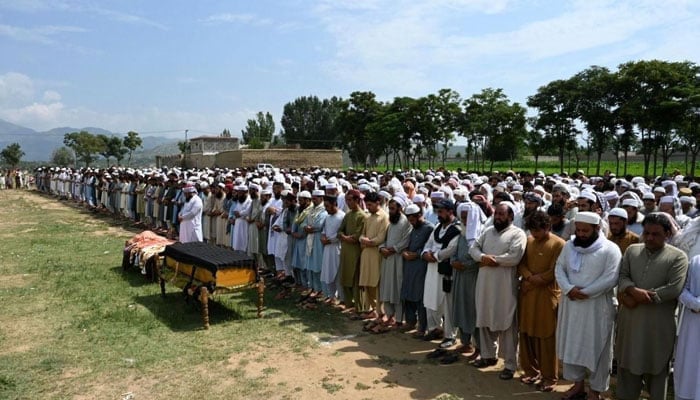 In this representational image, people offer funeral prayers. — AFP/File