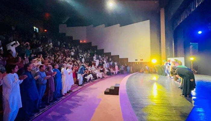 Representational image shows participants standing for claps at a theatres end on October 10, 2024. Facebook/Ajoka Theatre Pakistan