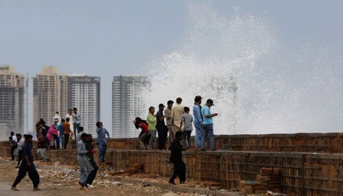 Representational image shows people gathers near the rising waves, before the arrival of the cyclonic storm, Biparjoy, over the Arabian Sea, at Clifton Beach, in Karachi, Pakistan June 13, 2023. — Reuters