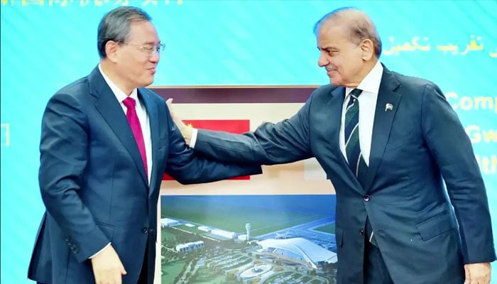 Chinese Premier Li Qiang and his Pakistani counterpart Shehbaz Sharif gesture after unveiling the plaque of Gwadar International Airport in Islamabad on October 14, 2024. — PID