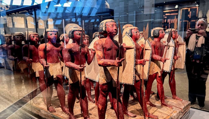 A visitor takes a photo of Pharaonic statues displayed at the Grand Staircase of the Grand Egyptian Museum during a partial trial in Giza, Egypt, October 15, 2024. — Reuters