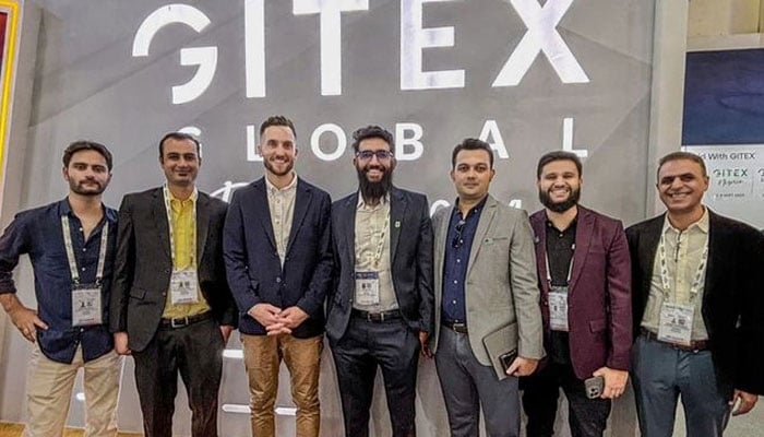 CEO Devsinc Usman Asif (pictured fourth from both sides) in a group photo. — Instagram/gt_magazine