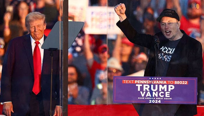 Tesla CEO and X owner Elon Musk speaks as Republican presidential nominee and former US president Donald Trump looks on during a rally at the site of the July assassination attempt against Trump, in Butler, Pennsylvania, US on October 5, 2024. — Reuters