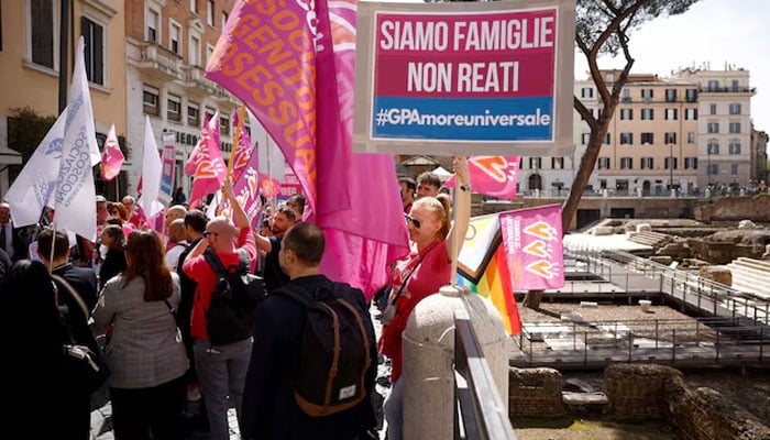 A woman holds a banner during a demonstration in support of surrogate motherhood in Rome, Italy, on April 5, 2024. — Reuters